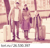 Family portrait of travellers with wheeled trollers in spring day. Стоковое фото, фотограф Яков Филимонов / Фотобанк Лори