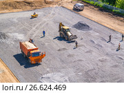 The construction of the school stadium. Excavator, dumper, roller (2017 год). Редакционное фото, фотограф Алексей Трегубов / Фотобанк Лори