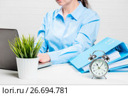 Accountant with a laptop and folders with documents out of focus in the office. Стоковое фото, фотограф Константин Лабунский / Фотобанк Лори
