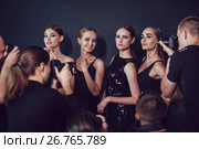 Photographers paparazzi take photos of women in cocktail dresses on dark background. Стоковое фото, фотограф Женя Канашкин / Фотобанк Лори