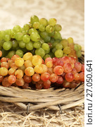 Juicy fresh red and white grapes in a wattled basket. Стоковое фото, фотограф ElenArt / Фотобанк Лори