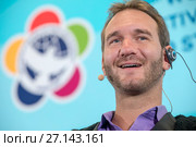 Австралийский оратор, писатель Ник Вуйчич выступает перед прессой на XIX Всемирном фестивале молодежи и студентов на фоне эмблемы фестиваля в Сочи, Россия (2017 год). Редакционное фото, фотограф Николай Винокуров / Фотобанк Лори
