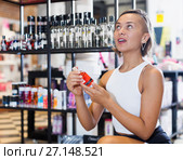 Adult female customer choosing bottle of pheromones. Стоковое фото, фотограф Яков Филимонов / Фотобанк Лори