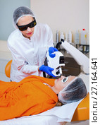 Woman removing hair from face with laser. Стоковое фото, фотограф Яков Филимонов / Фотобанк Лори