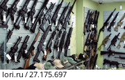 air-driven rifle hangs on the wall in army store. Стоковое видео, видеограф Яков Филимонов / Фотобанк Лори