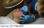 Woman doctor is preparing client for mesotherapy in clinic. Стоковое видео, видеограф Яков Филимонов / Фотобанк Лори