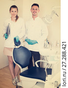 Stomatologist in white with his assistent are meeting next client near the chair. Стоковое фото, фотограф Яков Филимонов / Фотобанк Лори