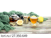 Useful herbal tea with a plant (Sideritis scardica) or Greek mountain tea with lemon in a cup and yellow chrysanthemums on a wooden table  close-up. Стоковое фото, фотограф Татьяна Ляпи / Фотобанк Лори