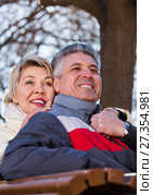 Smiling mature couple relaxing in park. Стоковое фото, фотограф Яков Филимонов / Фотобанк Лори