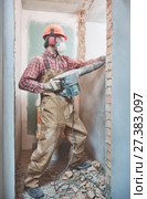 builder with demolition hammer breaking interior wall. Стоковое фото, фотограф Дмитрий Калиновский / Фотобанк Лори