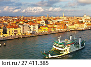 Italy. Venice. Top view of the Dorsoduro district, Church of San Trovaso, embankment Zattere and car ferry on the Giudecca Channel at the Sunset (2016 год). Редакционное фото, фотограф Виктория Катьянова / Фотобанк Лори