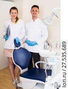 Stomatologist in white with his assistent are meeting next client near the chair. Стоковое фото, фотограф Яков Филимонов / Фотобанк Лори