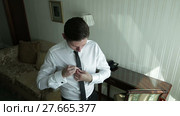 The groom adjusts his tie. Wedding preparation. Стоковое видео, видеограф Roman Larchikov / Фотобанк Лори