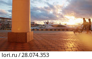 People are walking along a front in Sochi port, sunset, calm sea, Russia. Стоковое видео, видеограф Ирина Мойсеева / Фотобанк Лори