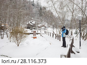 Man shoots showplace in wooden Russian Orthodox Monastery at winter day. Стоковое фото, фотограф Losevsky Pavel / Фотобанк Лори