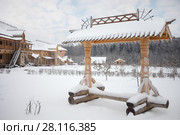 Wooden old-style bench, log buildings in Russian Orthodox Monastery at winter day (2016 год). Стоковое фото, фотограф Losevsky Pavel / Фотобанк Лори
