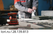 Blurred worker assembling the metal part by hand with pliers, tools for grinding metal and metal details in the foreground. Стоковое видео, видеограф Константин Шишкин / Фотобанк Лори