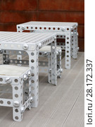 Holed chairs, benches and tables made from metal like child building kit. Стоковое фото, фотограф Losevsky Pavel / Фотобанк Лори