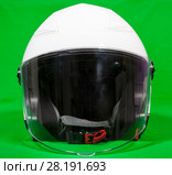 Open face white motorcycle helmet with attached face shield, front view, a green background. Стоковое фото, фотограф Кекяляйнен Андрей / Фотобанк Лори