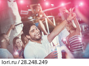 positive male joying and thumbs up on party in the club with coc. Стоковое фото, фотограф Яков Филимонов / Фотобанк Лори
