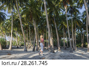 Young beautiful woman is walking in a rainforest among palm trees. Стоковое фото, фотограф Некрасов Андрей / Фотобанк Лори