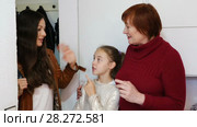 Happy young mother leaving daughter with grandma at home, saying goodbye. Стоковое видео, видеограф Яков Филимонов / Фотобанк Лори