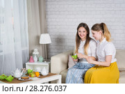 Two young girls are sitting on the couch. Стоковое фото, фотограф Типляшина Евгения / Фотобанк Лори