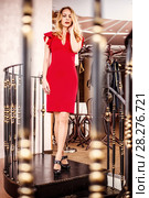 Beautiful blond woman red close-fitting dress. Стоковое фото, фотограф katalinks / Фотобанк Лори