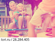 Company of kids are teetering on the swing. Стоковое фото, фотограф Яков Филимонов / Фотобанк Лори