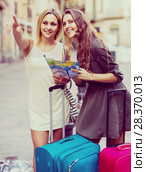 Two women with baggage checking route outdoors. Стоковое фото, фотограф Яков Филимонов / Фотобанк Лори