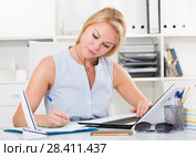 portrait of girl business manager writing and working with laptop in office workplace. Стоковое фото, фотограф Яков Филимонов / Фотобанк Лори
