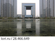 TIANJIN, CHINA - APRIL 8, 2017. A modern building along the Haihe River in Tianjin, China. Редакционное фото, фотограф Яна Королёва / Фотобанк Лори