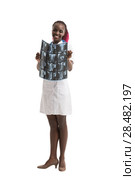 Closeup portrait of intellectual african woman healthcare doctor with white labcoat, looking at neck x-ray radiographic image, ct scan, mri, isolated white background. Radiology department. Стоковое фото, агентство Ingram Publishing / Фотобанк Лори