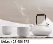 Teapot and cups on table at comfortable relaxation lounge. Стоковое фото, фотограф Kirill Kedrinskiy / Ingram Publishing / Фотобанк Лори