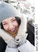 Young girl in winter outfit smile with snow background. Стоковое фото, фотограф Kirill Kedrinskiy / Ingram Publishing / Фотобанк Лори