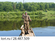 Счастливый рыбак держит в руке удочку с пойманной рыбой. Тульская область. Заокский район. Река Ока. Стоковое фото, фотограф Игорь Низов / Фотобанк Лори
