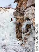 Ice climber on a steep ice fall; vertical frame; west Alps, Italy, Europe. Стоковое фото, агентство Ingram Publishing / Фотобанк Лори