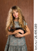 Children fashion farmer girl holding hen in retro vintage background. Стоковое фото, фотограф Tono Balaguer / Ingram Publishing / Фотобанк Лори
