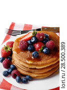 White plate full of pancakes with strawberries raspberries blueberries and honey on white. Стоковое фото, фотограф Olena Mykhaylova / Ingram Publishing / Фотобанк Лори