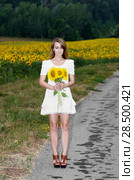 Young woman in white short dress with sunflowers at country road. Стоковое фото, фотограф Olena Mykhaylova / Ingram Publishing / Фотобанк Лори