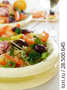 Seafood spaghetti pasta dish with octopus, shrimps, cherry tomatoes and olives. Стоковое фото, фотограф Olena Mykhaylova / Ingram Publishing / Фотобанк Лори