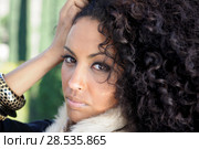 Close-up portrait of a young black woman, afro hairstyle, in urban background. Стоковое фото, фотограф Javier Sánchez Mingorance / Ingram Publishing / Фотобанк Лори