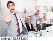 Smiling businessman and team delighted with achievements. Стоковое фото, фотограф Яков Филимонов / Фотобанк Лори