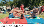KAZAN, RUSSIA - JUNE 23, 2018: Traditional Tatar festival Sabantuy - Strong men wrestling outdoors at summer day. Редакционное видео, видеограф Константин Шишкин / Фотобанк Лори
