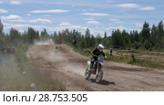 June 10, 2018 Russian Federation, Bryansk region, Ivot - Extreme sports, cross motocross. The motorcyclist enters the turn on the race track. Dirt is flying from under the wheels. The machine overcomes obstacles. Athletes fly through the air. slow motion. Редакционное видео, видеограф Константин Мерцалов / Фотобанк Лори