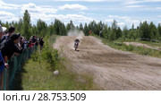 June 10, 2018 Russian Federation, Bryansk region, Ivot - Extreme sports, cross motocross. The motorcyclist enters the turn on the race track. Dirt is flying from under the wheels. The machine overcomes obstacles. Athletes fly through the air. slow motion. Редакционное видео, видеограф Константин Мерцалов / Фотобанк Лори