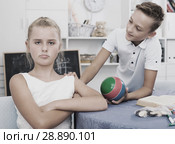 Boy is excusing for the offendedly girl and offering to play ball. Стоковое фото, фотограф Яков Филимонов / Фотобанк Лори