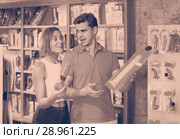 woman and man bayers choosing long rubber phallus in the sex shop. Стоковое фото, фотограф Яков Филимонов / Фотобанк Лори