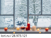 burning candles on a windowsill. Стоковое фото, фотограф Майя Крученкова / Фотобанк Лори