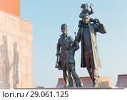 Россия, Тюменская область, Ханты-Мансийский национальный округ; город Нефтеюганск; Молодая семья в памятнике  "Первопроходцам, основателям города Нефтеюганска, посвящается" (2018 год). Редакционное фото, фотограф Александр Циликин / Фотобанк Лори